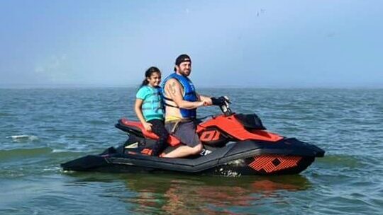 two people on a wave runner in the ocean - jet ski rental in Surfside beach tx