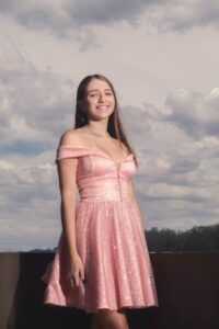 woman in pink prom beaded short off shoulder dress at a surfside prom party