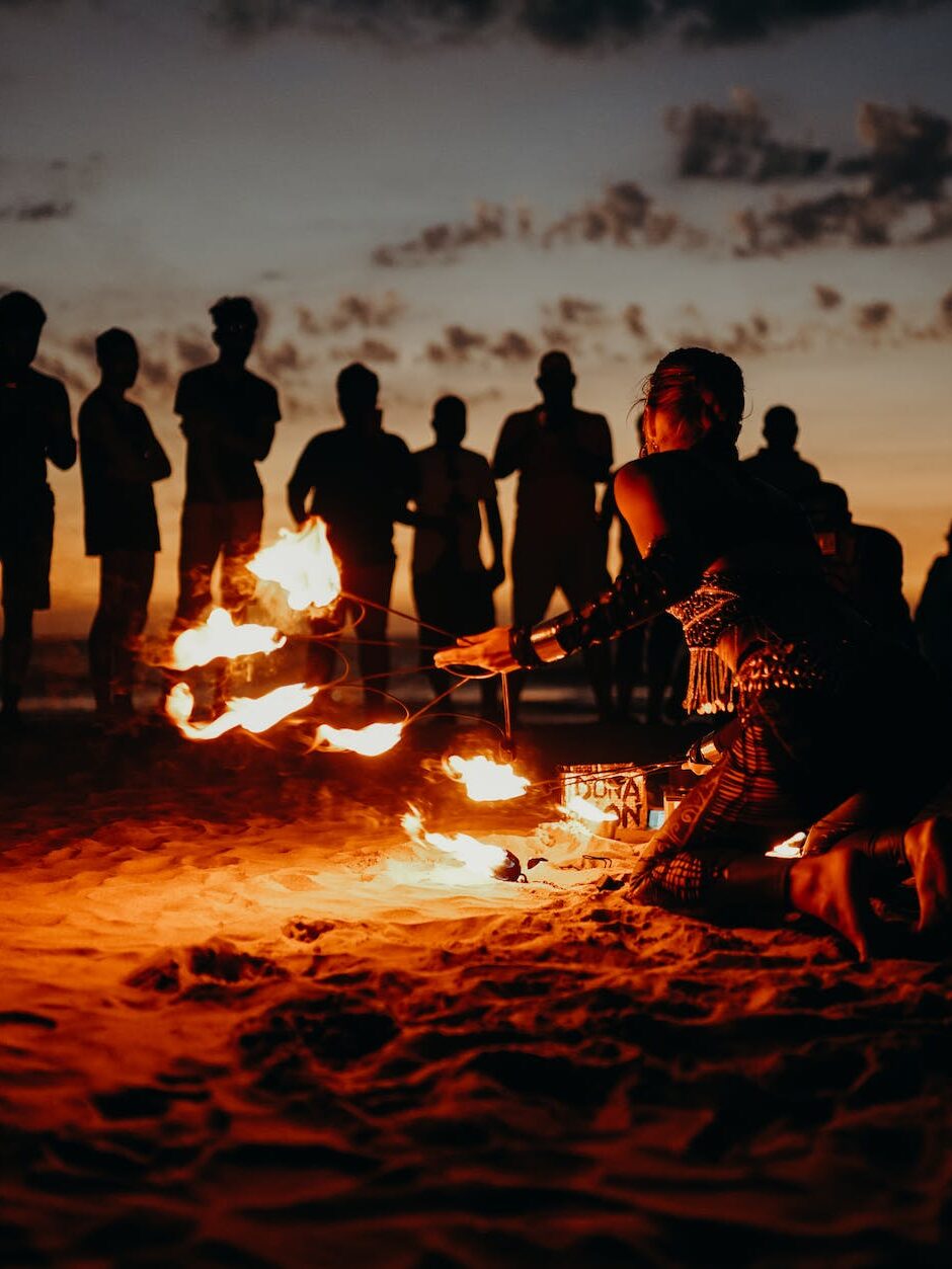 people standing on beach during sunset at a surfside prom party - houston prom party ideas