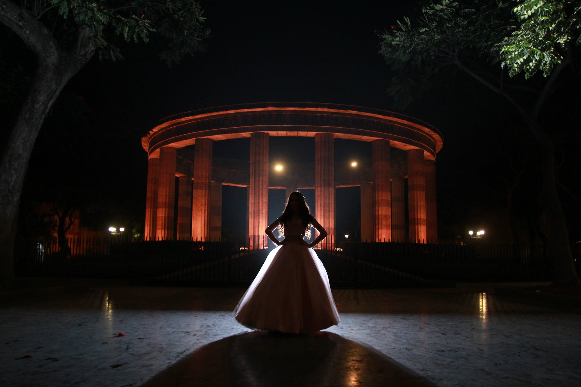 woman in pink dress standing at the entrance to a Houston prom party